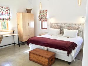 a bedroom with a large white bed and a table at Darling Lodge Guest House in Darling