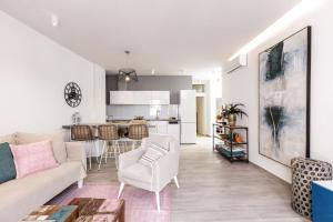 a living room with a couch and a kitchen at Kristin's Maisonette - Roof Terrace & Sauna in Rethymno Town