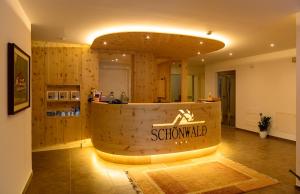 a restaurant with a wooden counter in a room at Aktiv Hotel Schönwald in Nova Levante