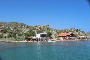 a group of houses on the shore of a body of water at KARABİBİK BUNGALOW in Demre
