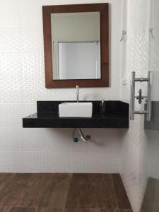 a bathroom with a sink and a mirror on the wall at Villa Maria in Capitólio +53 photos
