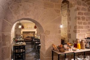 a restaurant with an archway with tables and chairs at Hotel des Deux-Iles - Notre-Dame in Paris +62 photos