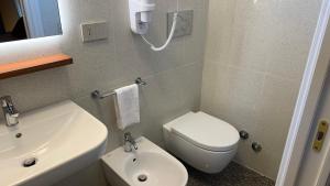 a bathroom with a white toilet and a sink at Dimora del Leone Gaeta in Gaeta