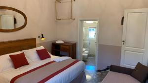 a hotel room with a bed and a mirror at Dimora del Leone Gaeta in Gaeta