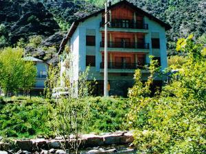 
a large building with a view of a river at Hotel Puitavaca in Vall de Cardos
