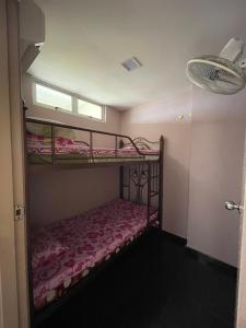 a bedroom with two bunk beds and a window at GLORY BEACH 3 bedroom Seaview Resort-PRIVATE in Port Dickson