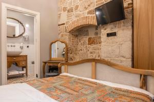 a bedroom with a bed and a fireplace at Hotel Lykia Old Town Antalya in Antalya