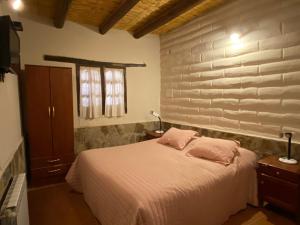 A bed or beds in a room at Hosteria Las Tinajas