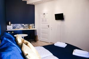 a bedroom with a bed and a desk and a tv at EURO-ROOM in Krakow