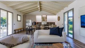 a living room with a white couch and a table at Villa Mia 6, Emma Villas in Mercato Saraceno