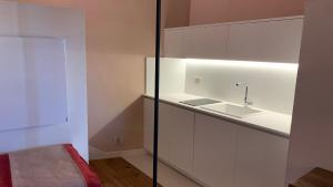 a kitchen with white cabinets and a sink at Dimora del Leone Gaeta in Gaeta