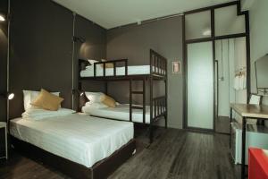 a bedroom with two bunk beds and a mirror at Fashen Poshtel in Chiang Mai