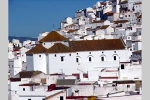 a group of white buildings on a mountain at Beautiful Duplex with a Patio in Alcalá de los Gazules