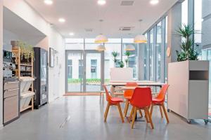 a dining room with a table and four chairs at Student Factory Lille Euratechnologies in Lille +9 photos