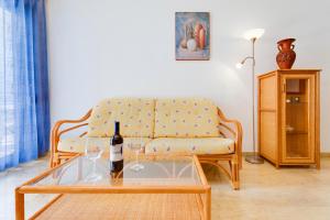 a living room with a couch and a table with wine glasses at Apartament PALMERA 100m od morza in Orihuela