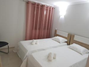 A bed or beds in a room at Forte Beach- Albufeira