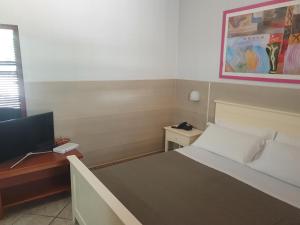 Postel nebo postele na pokoji v ubytování La Casarana Wellness Ecoresort