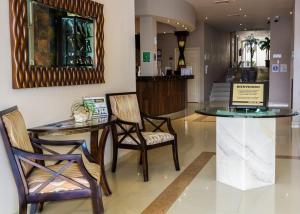 eine Lobby mit Tisch, Stühlen und einem Tresen in der Unterkunft BONITTO INN® Tampico Lomas in Tampico