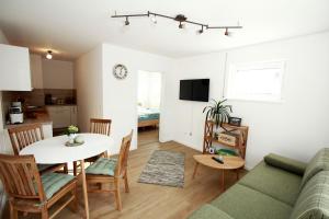 a living room and kitchen with a table and a couch at Ferienwohnung Fembacher in Bad Reichenhall