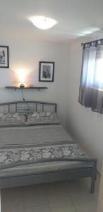 Postel nebo postele na pokoji v ubytování Apartmani Ivišić