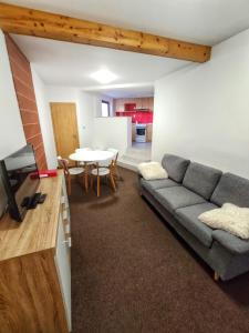 a living room with a couch and a table at Penzion Svatý Jan in Turnov