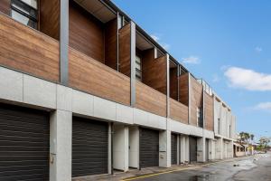an external view of a building with garage doors at Little Grenfell Apartments by Urban Rest in Rose Park