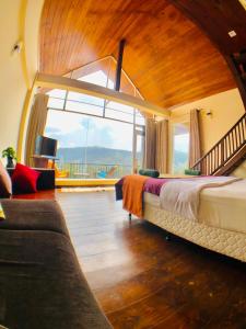 a bedroom with two beds and a large window at Pigeons Nest in Nuwara Eliya