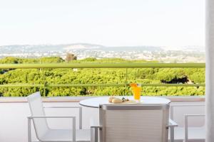 a table and chairs on a balcony with a view at The Patio Suite Hotel in Albufeira