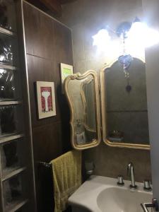 a bathroom with a sink and a large mirror at Los 3 Gringos Casa Bosque P Ramos in Mar del Plata