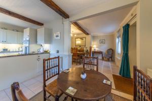 a kitchen and living room with a wooden table and chairs at Turford House, Ludlow in Ludlow