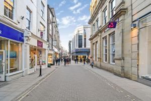 a street in a city with people walking down the street at Turpin Quarter in the centre of the city, sleeps 6 in York
