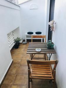 a room with a wooden table and a bench at Carolina’S Nest in Casal Palocco