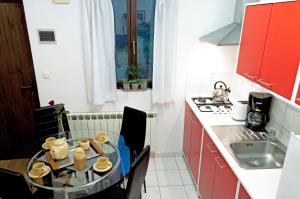 eine kleine Küche mit einem Tisch und einem Waschbecken in der Unterkunft Apartment Rosa 1 (AP-A4) in Rovinj