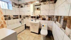 a bathroom with a toilet and a sink and a tub at Шевченко 1 in Kropyvnytskyi