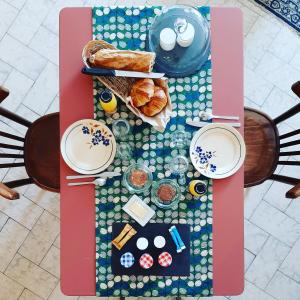 a table with bread and pastries on it at Maison Saint James in Montélimar