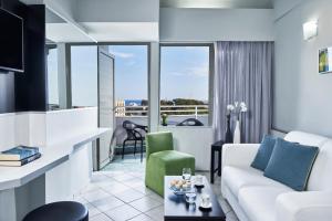 a living room with a couch and a table at AQUAMARE CITY and BEACH in Rhodes Town