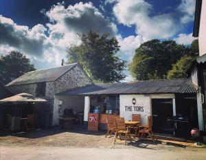 a building with chairs and a sign that reads the trusts at The Tors in Okehampton