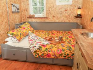 a bed with a tray on it in a room at Bramley Orchard Glamping in Retford