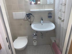 a small bathroom with a sink and a toilet at Hotel am Neumarkt in Zeitz