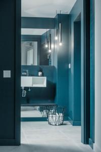 a bathroom with blue walls and a white sink at Tramuntana Hotel - Adults Only in Cadaqués