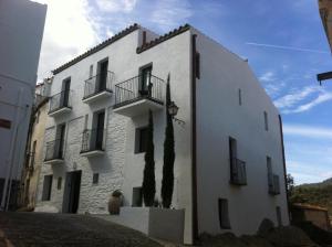 a white building with balconies on the side of it at Tramuntana Hotel - Adults Only in Cadaqués