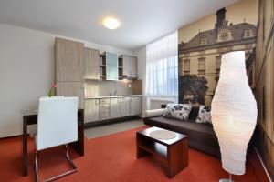 a living room with a couch and a vase at Hotel Palác in Olomouc