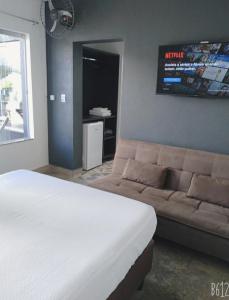 a bedroom with a bed and a couch at Villa Maria in Capitólio +53 photos