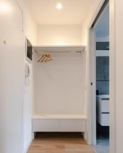 een kamer met een kast met een deur open bij Al 32 Apartment in Milaan
