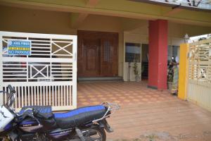 a motorcycle parked in front of a house at Sumi Palace Annexure in Vallam