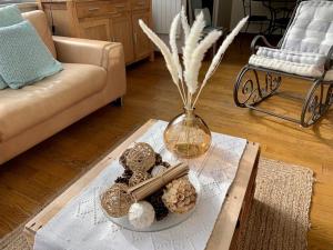 - un salon avec un vase et une table avec des biscuits dans l'établissement Tiny house au cœur de Bayeux, à Bayeux