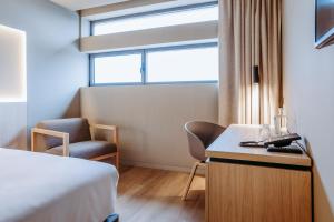 Postel nebo postele na pokoji v ubytování Mercure Fátima