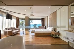 a bedroom with a bed and a living room at Yacht Hotel in Vlorë