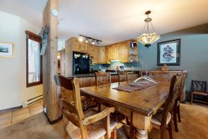 a dining room and kitchen with a wooden table and chairs at Granite A in Jackson
