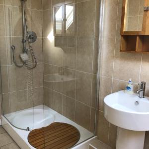a bathroom with a shower with a toilet and a sink at The View in Grange Over Sands